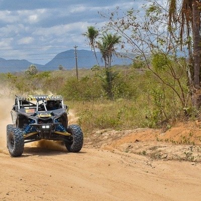 a truck driving down a dirt road